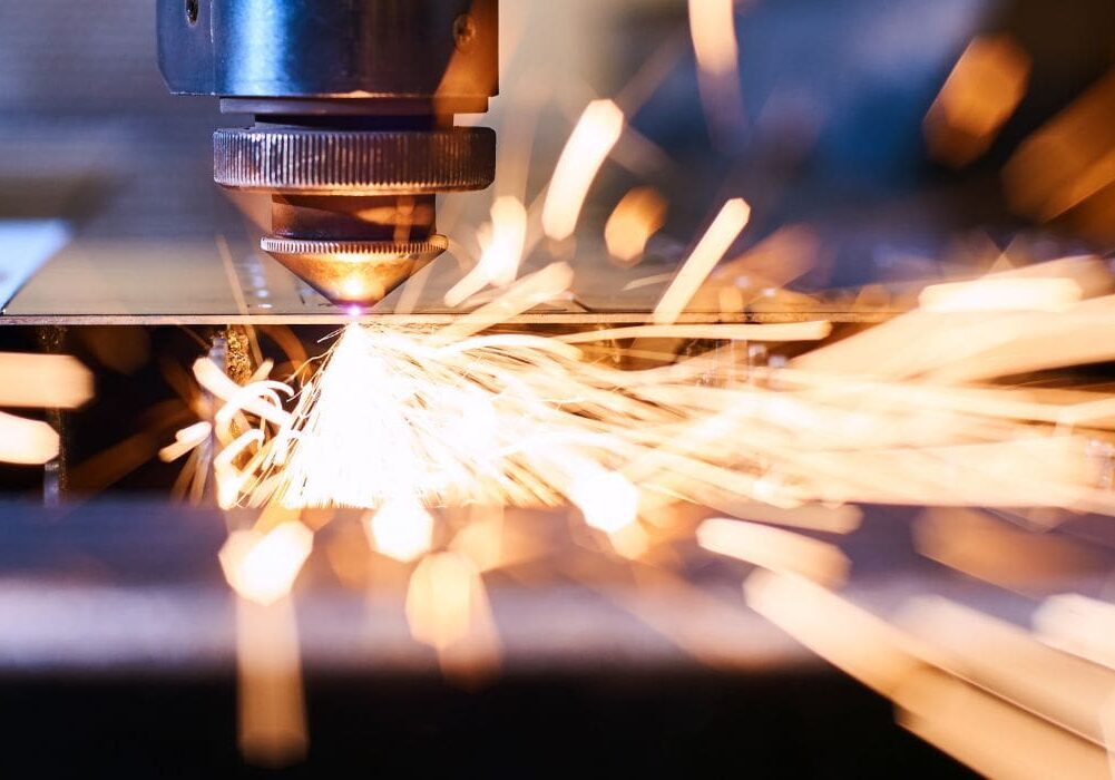 Laser cutting metal with bright sparks.